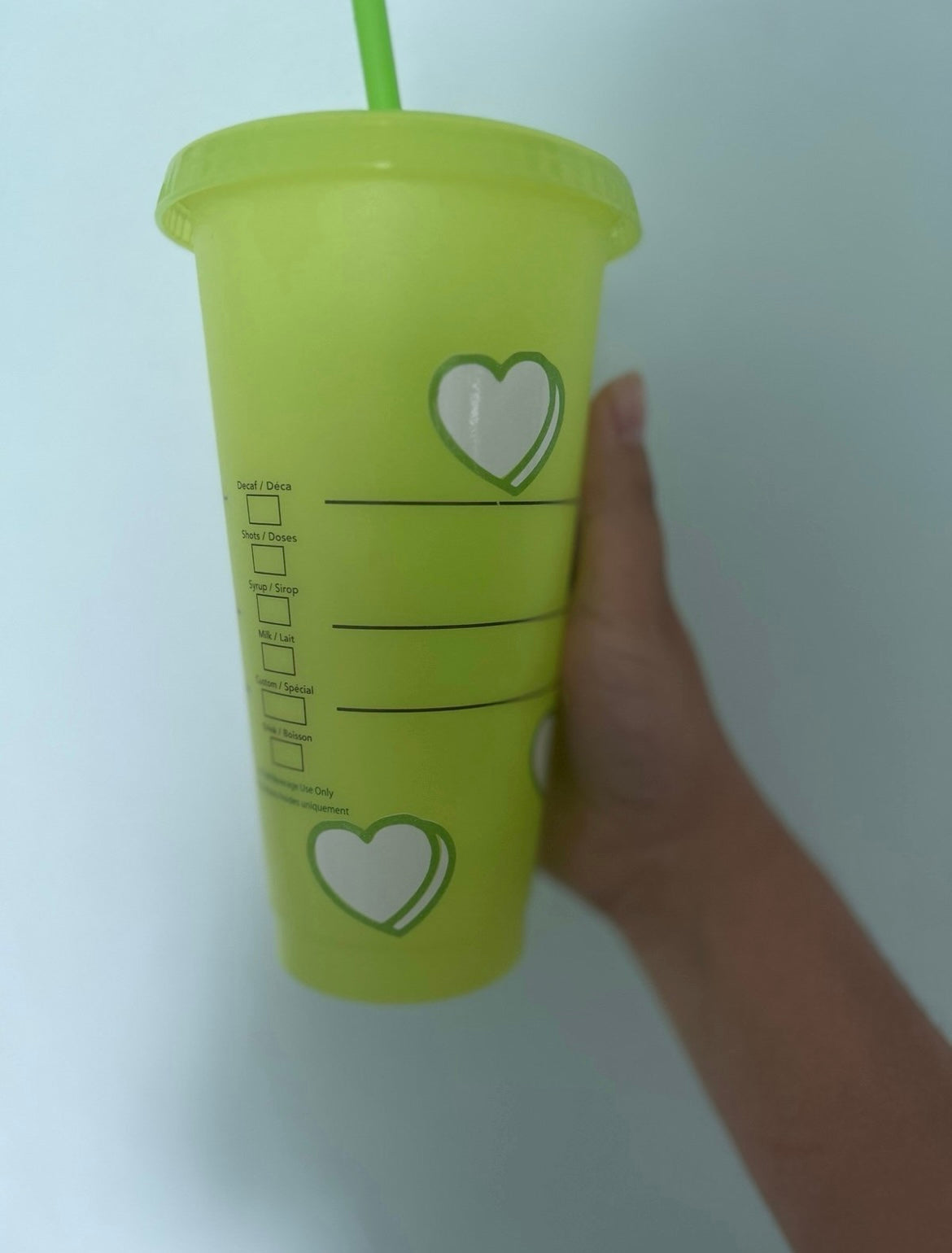 Green Starbucks cup with hearts