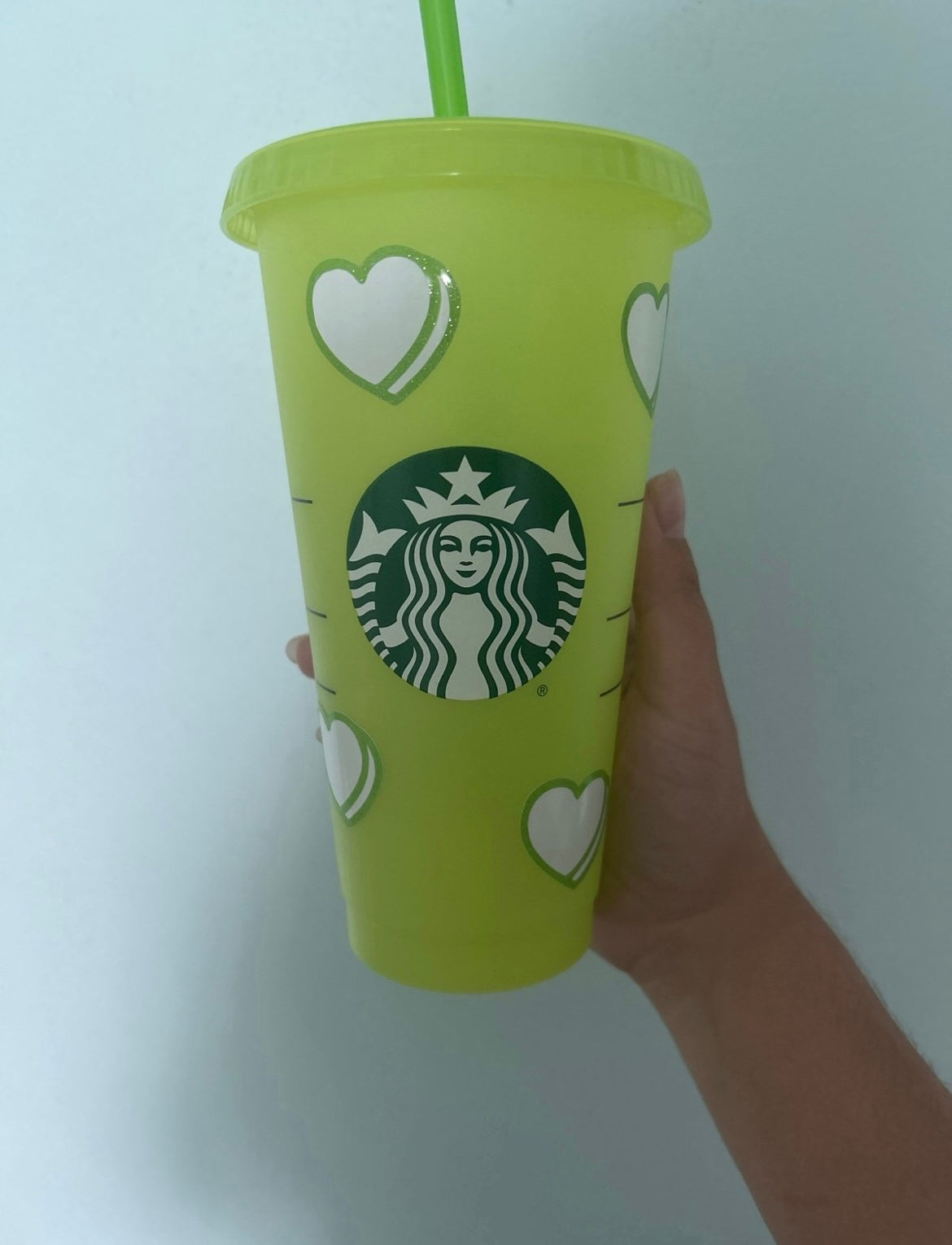 Green Starbucks cup with hearts